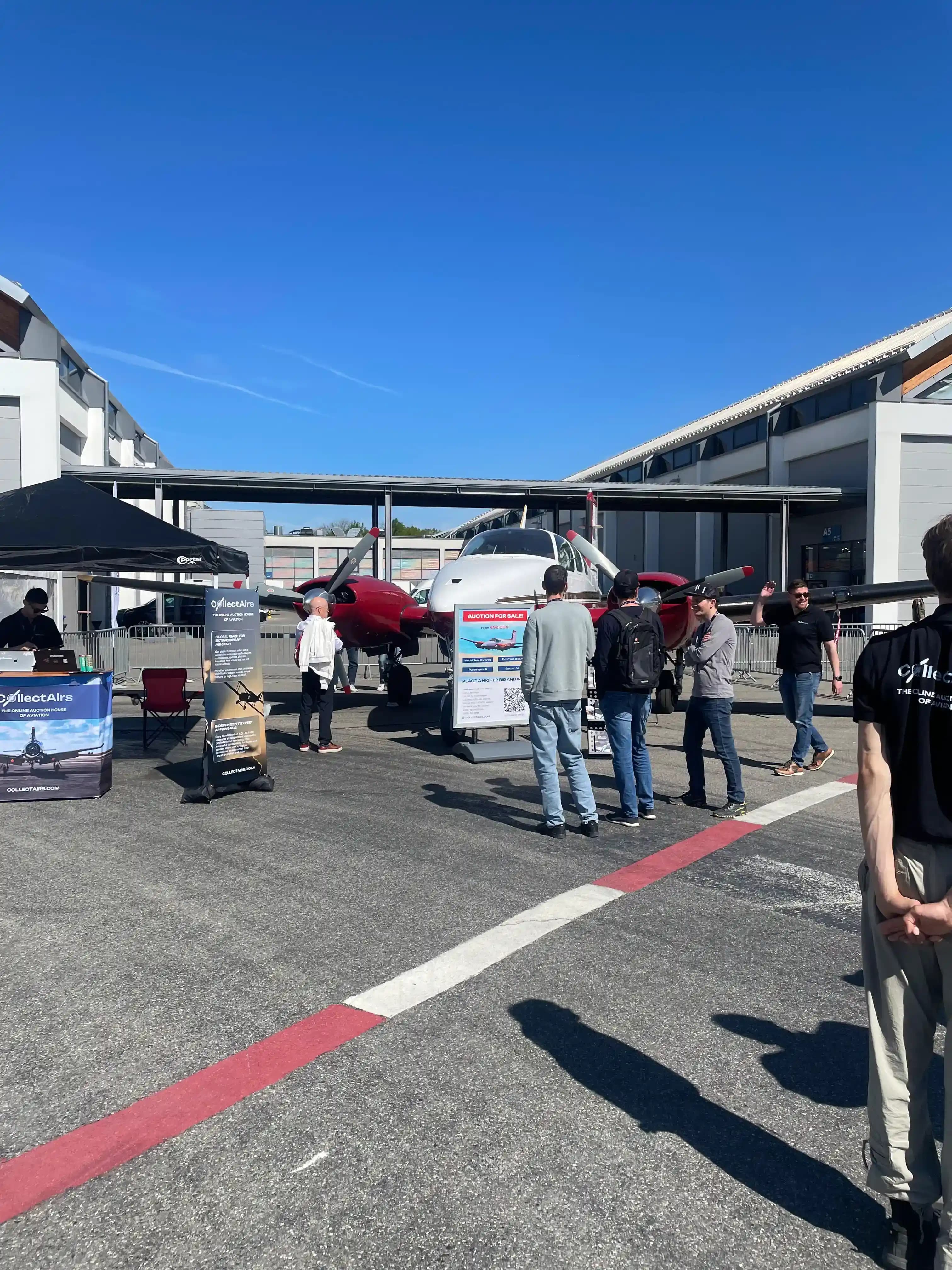 CollectAirs booth with Beechcraft Twin Bonanza and live auction at AERO Friedrichshafen 2026