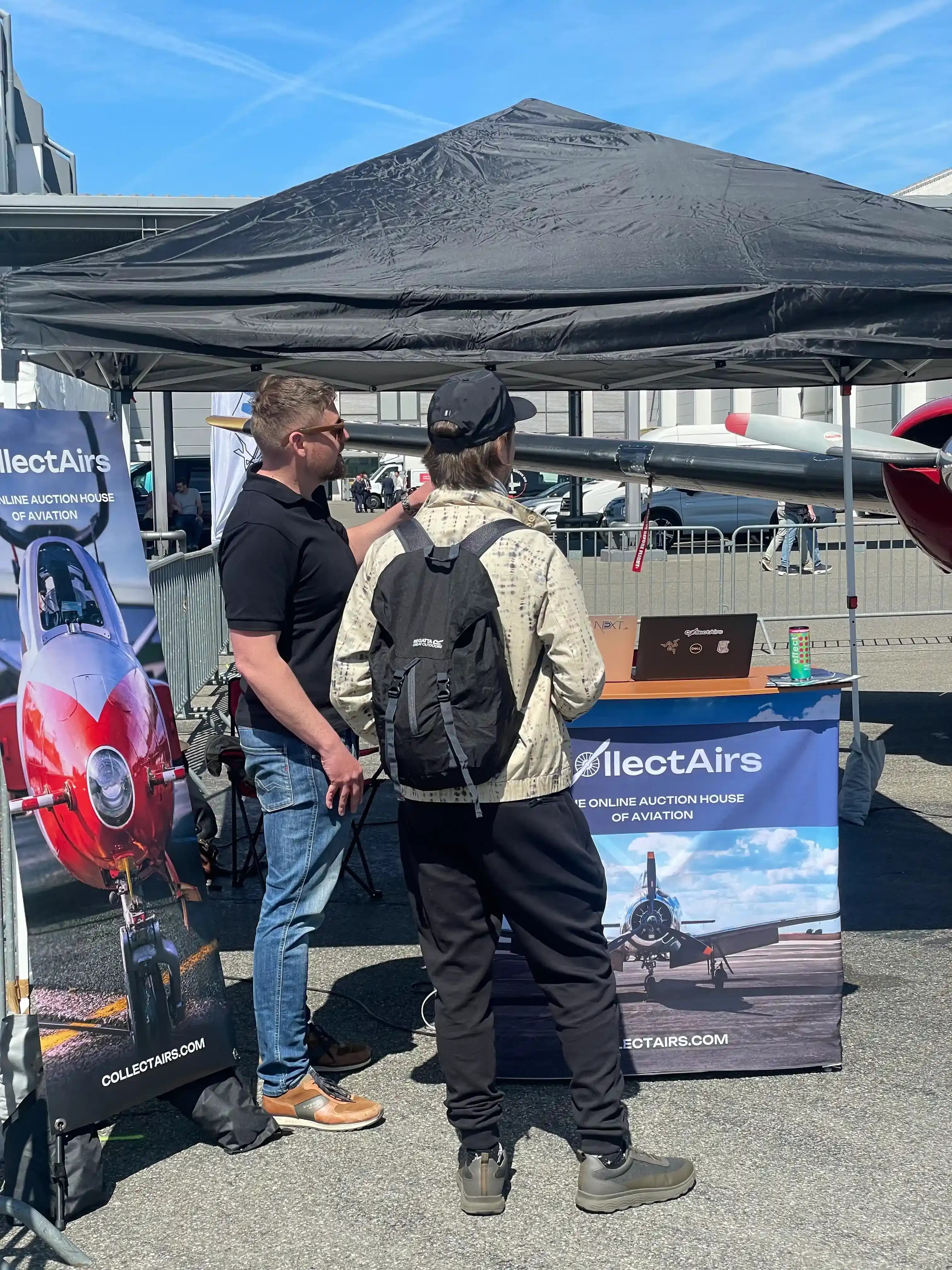 Visitors speaking with CollectAirs representatives at AERO Friedrichshafen booth