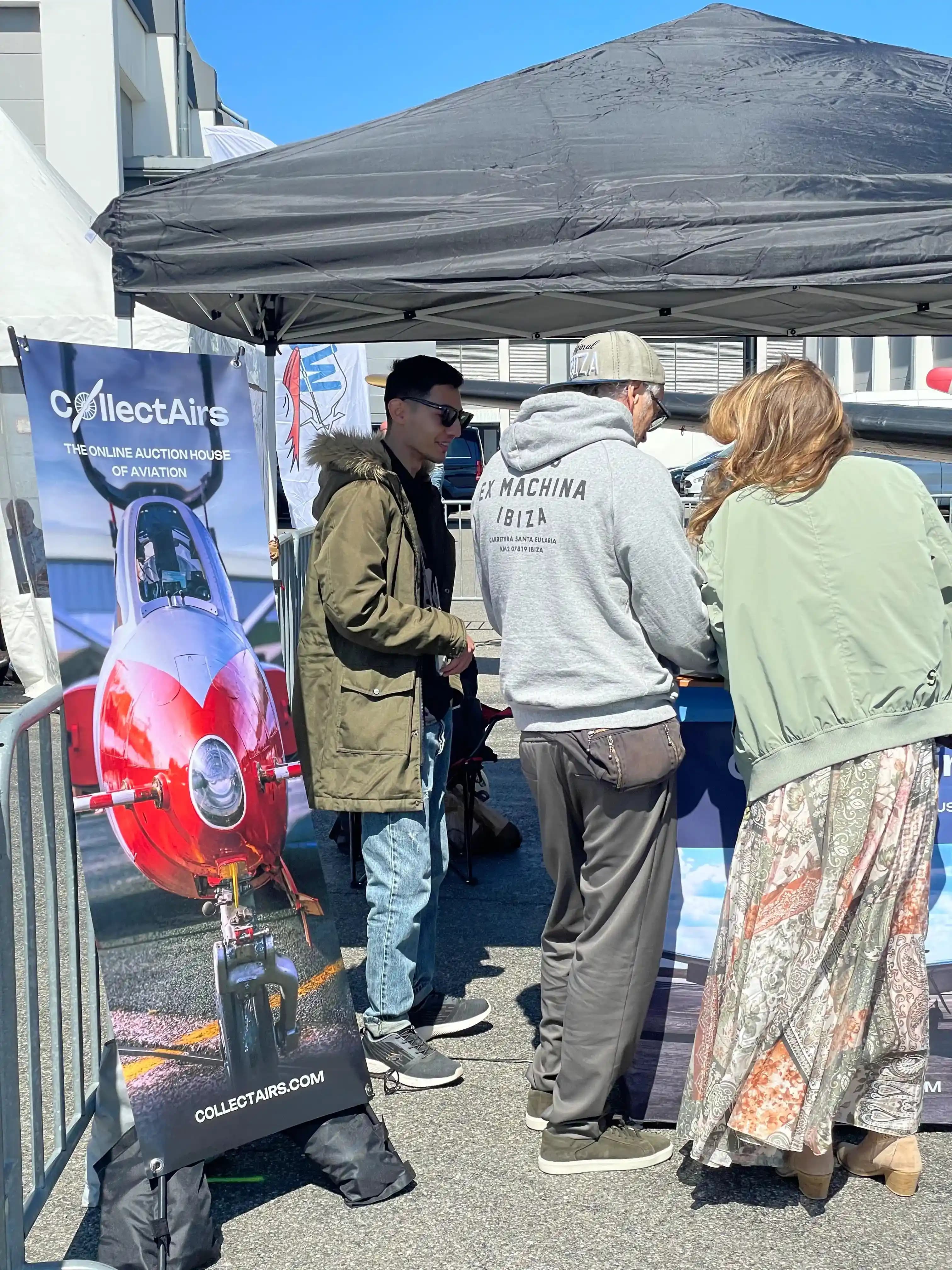 CollectAirs roll-up banner at outdoor AERO expo booth — online auction house of aviation