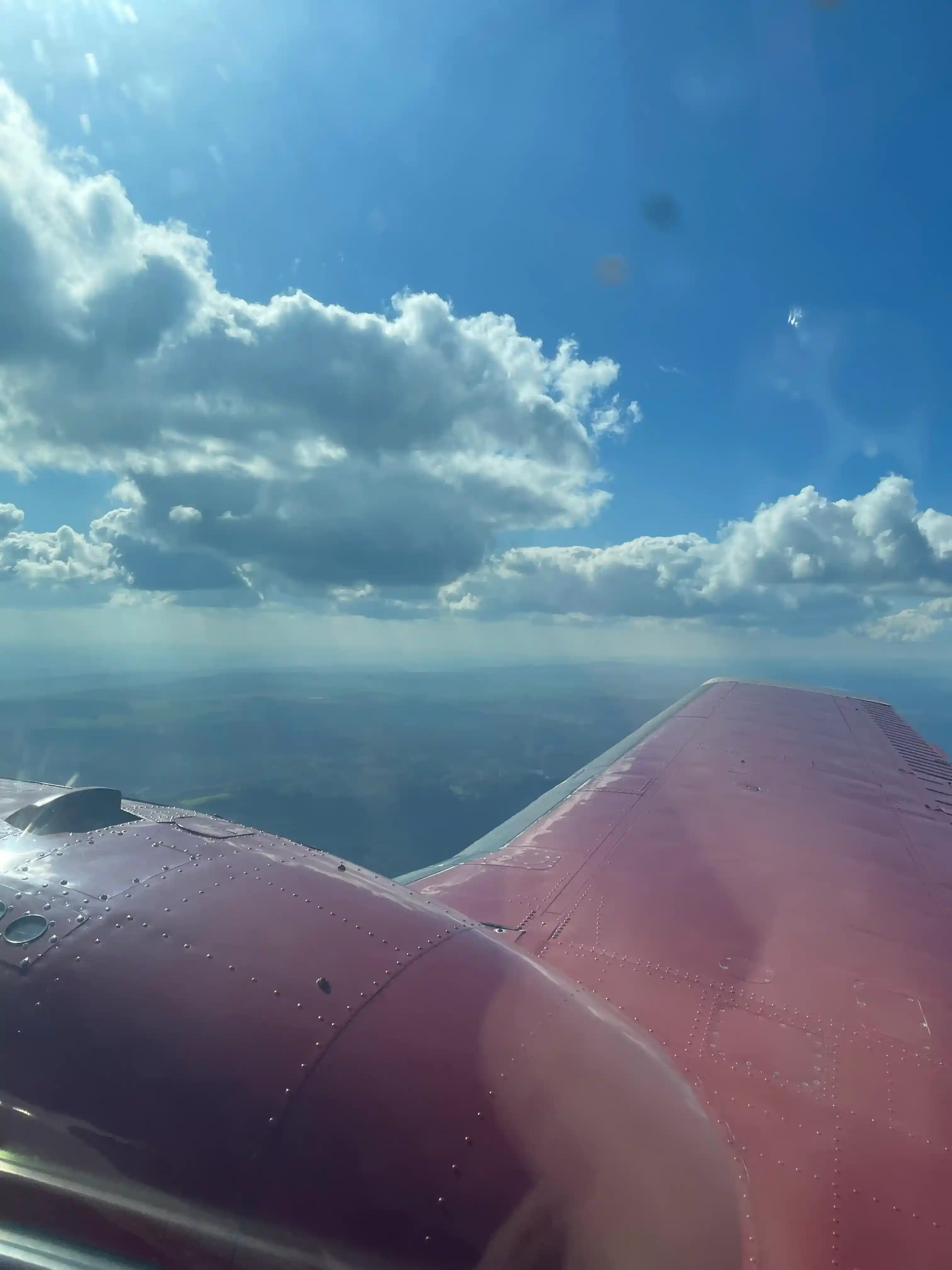 In-flight wing view with clouds on route to AERO Friedrichshafen 2026