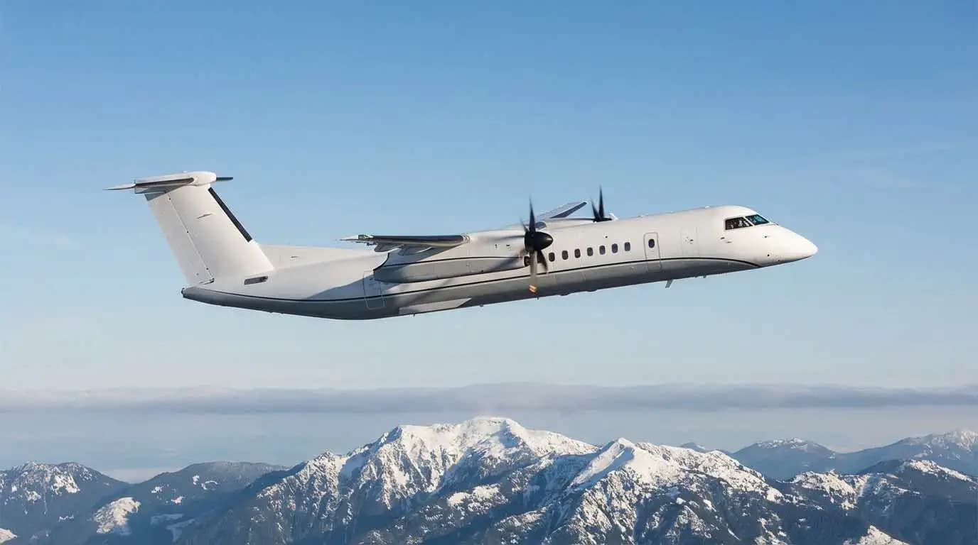 Beechcraft King Air in flight over mountain terrain at cruising altitude showing turboprop silhouette