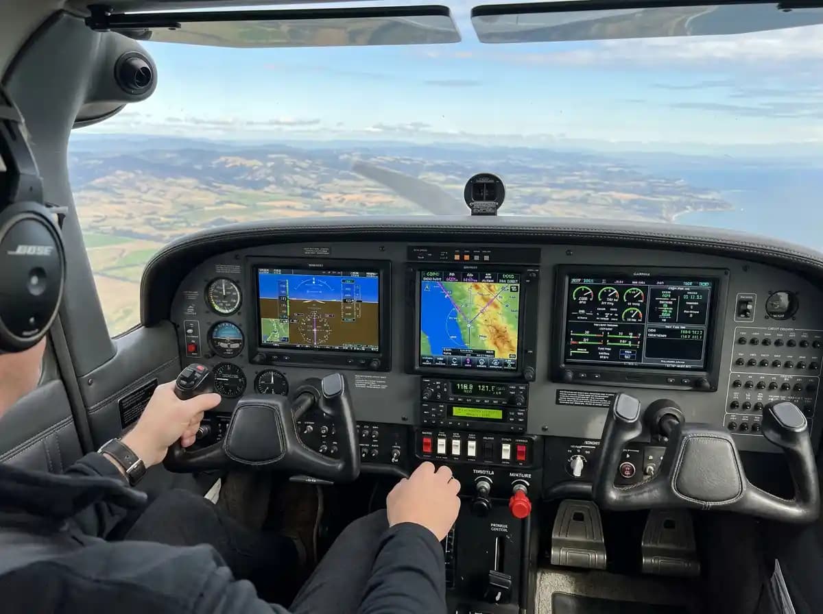 Beechcraft V-tail Bonanza cockpit showing modern avionics panel with GPS navigator and glass display