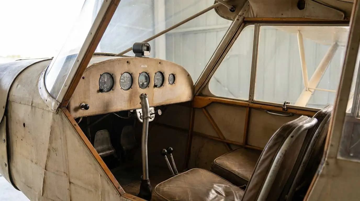 Piper J3 Cub cockpit interior showing minimalist instrument panel and simple control arrangement